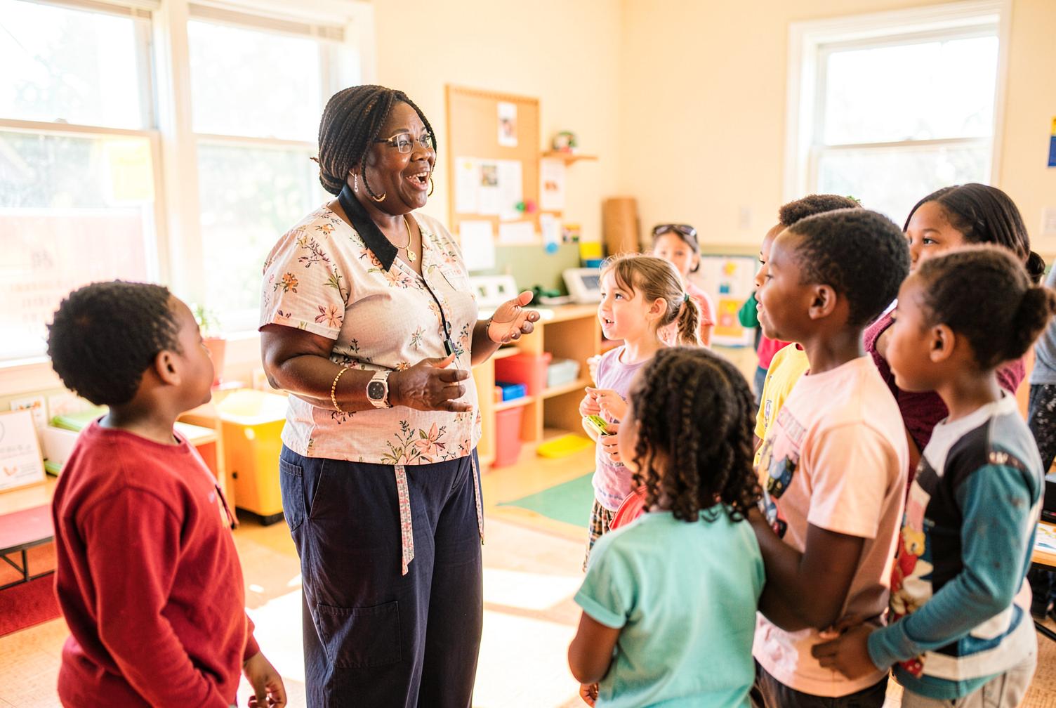 A community educator speaks with a group of children in a sunlit learning room